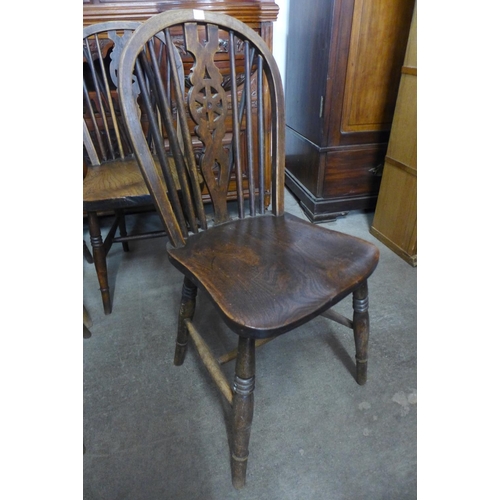 236 - A set of four Victorian elm and beech wheelback chairs