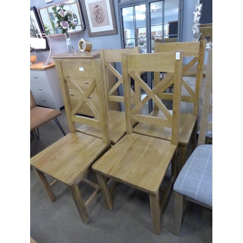 1544 - A set of four Winchester oak cross back chairs with wooden seat  *This lot is subject to VAT -  Unev... 