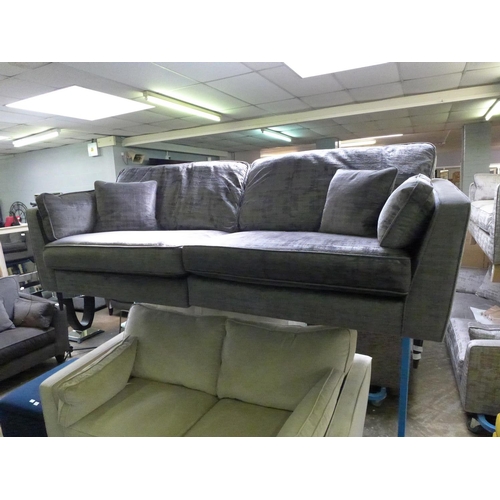 1552 - A grey crushed velvet three seater sofa  - Damaged under liner.