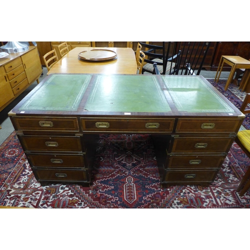 107 - A campaign style mahogany, brass mounted and green leather topped desk