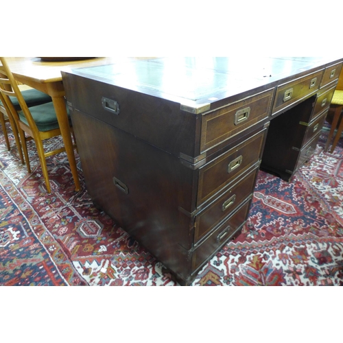 107 - A campaign style mahogany, brass mounted and green leather topped desk