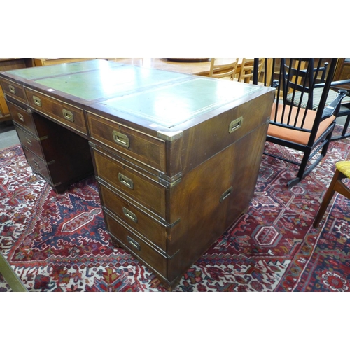 107 - A campaign style mahogany, brass mounted and green leather topped desk