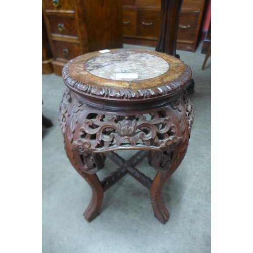 108 - A small Chinese carved hardwood and marble topped jardiniere stand