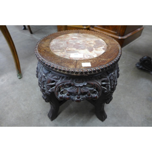 109 - A small Chinese carved hardwood and marble topped jardiniere stand