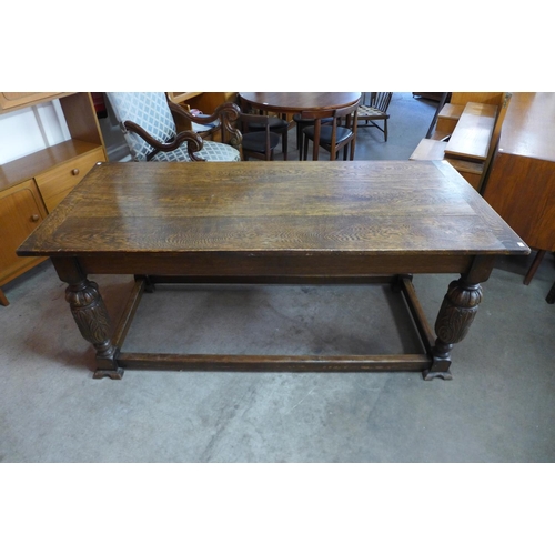 119 - A 17th Century style carved oak refectory table