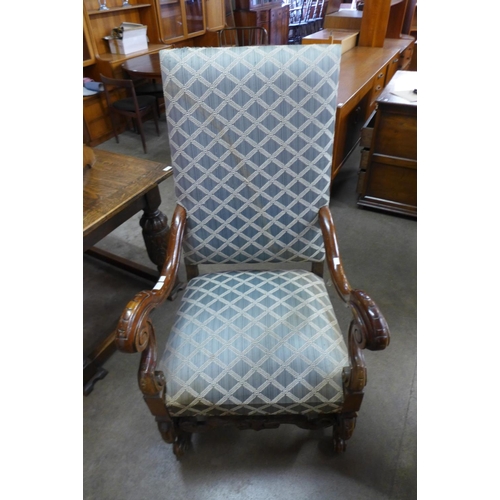 122 - A French carved walnut and upholstered fauteuil