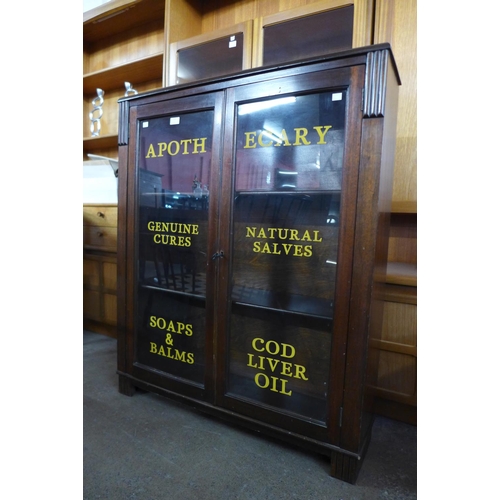 123 - A mahogany two door cabinet, bearing apothecary inscription to doors