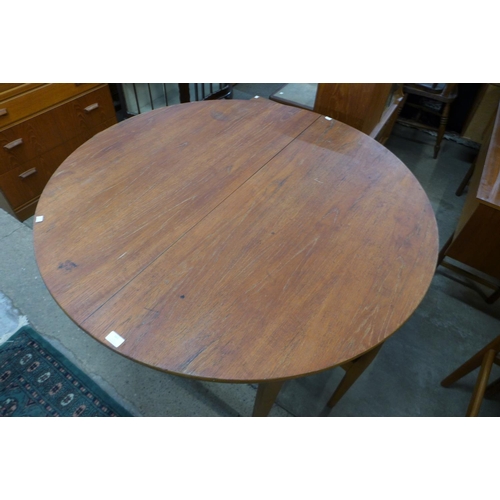 161 - A Nathan teak extending dining table and four chairs