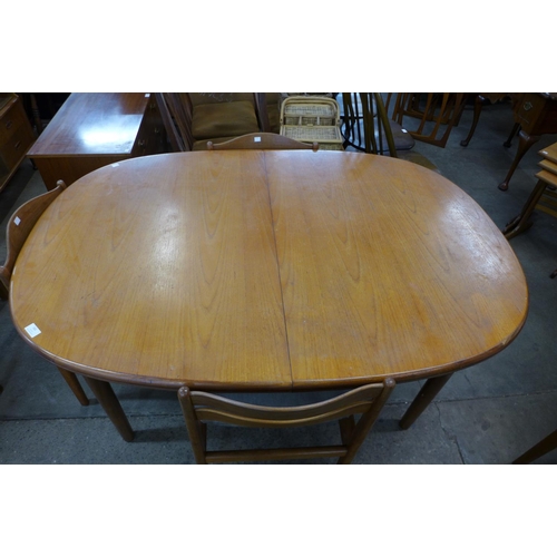 162 - A teak extending dining table and four chairs