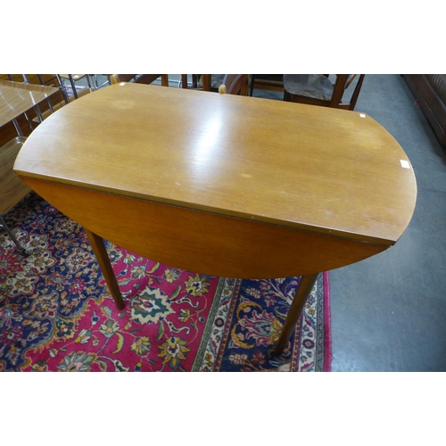 173 - A teak drop leaf table and four chairs