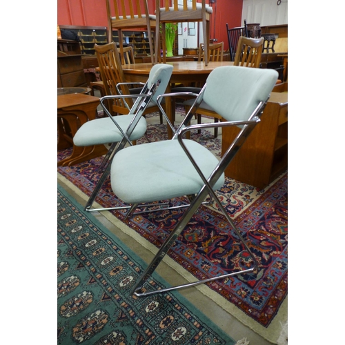 195 - A pair of Ernest Race chrome and upholstered elbow chairs