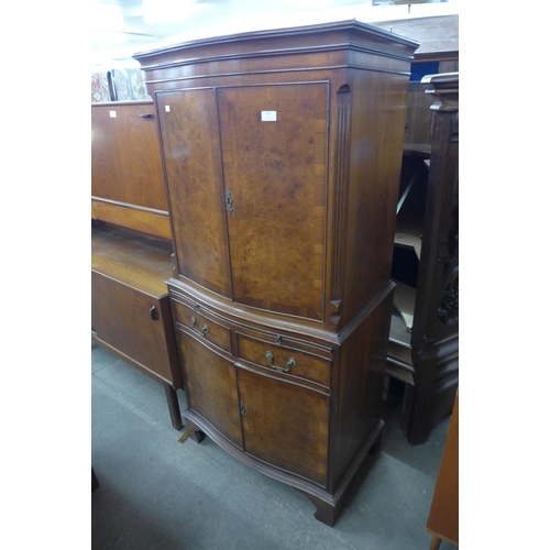 224 - A mahogany and burr walnut serpentine side cabinet