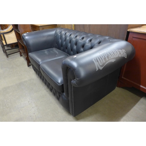 228 - A Kopparberg black leather Chesterfield settee