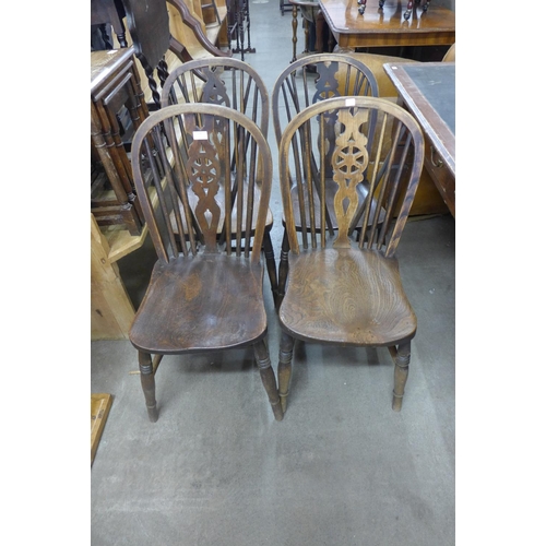 236 - A set of four Victorian elm and beech wheelback chairs