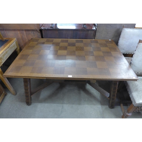 243 - A French Breton oak draw-leaf dining table