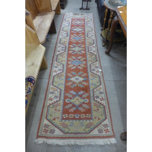 272 - A terracotta ground runner rug