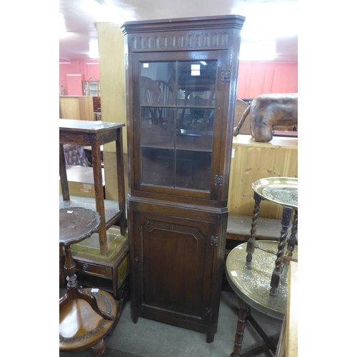 288 - A carved oak freestanding corner cabinet