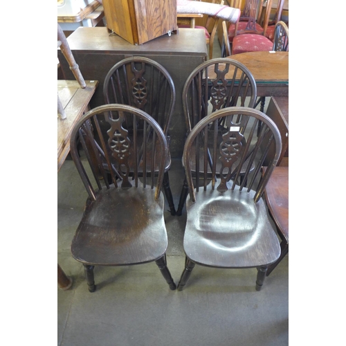 300 - A set of four beech and elm wheelback chairs