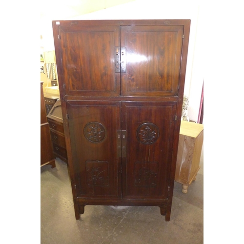 323 - A Chinese elm four door cupboard