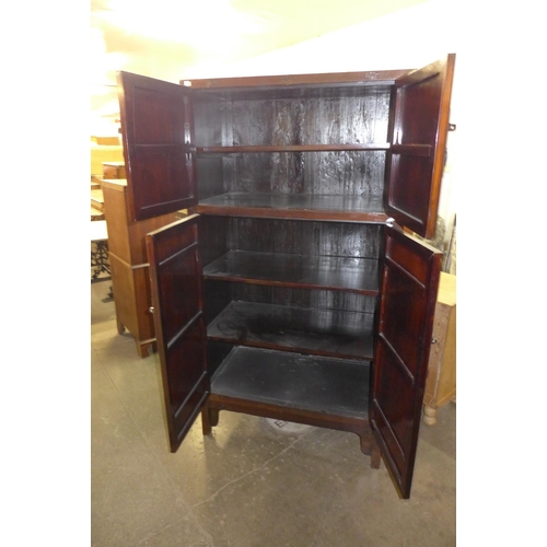 323 - A Chinese elm four door cupboard