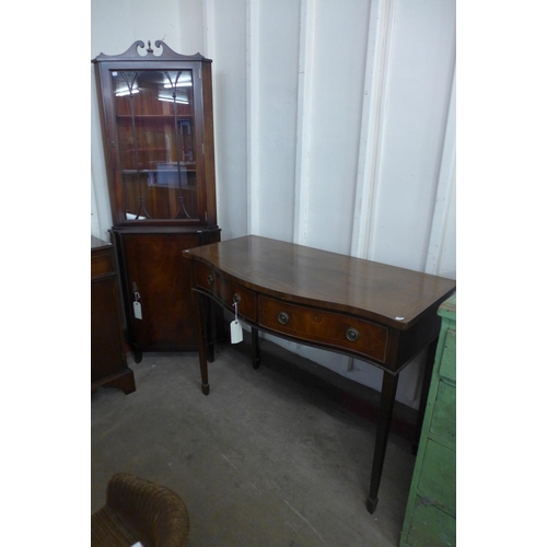 350 - A mahogany breakfront sideboard, a serpentine side table and a corner cabinet