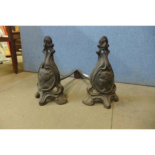 377 - A pair of French Art Nouveau cast iron andirons