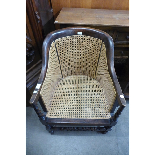 69 - An oak barleytwist bergere armchair