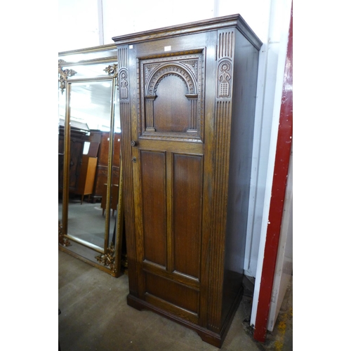 73 - A carved Ipswich oak hall robe