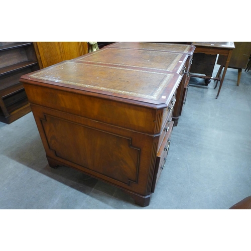 86 - A mahogany and brown leather topped breakfront library desk