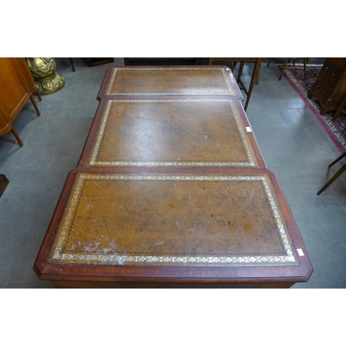 86 - A mahogany and brown leather topped breakfront library desk