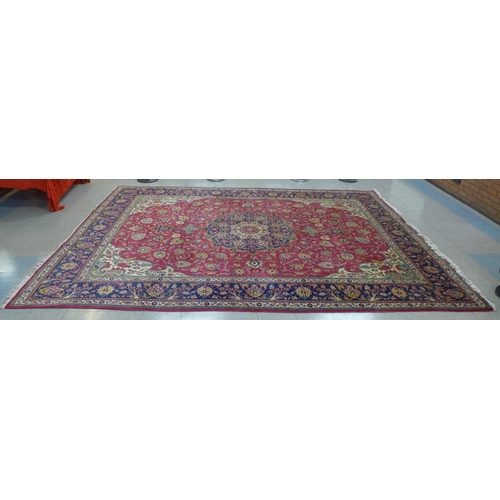 90 - A large red ground geometric patterned rug, 405 x 310cms