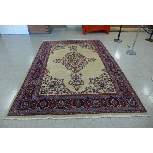 91 - A large cream ground geomertic patterned rug, 360 x 253cms