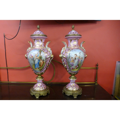 97 - A pair of large French style pink porcelain and gilt metal mounted vases and covers, with gilded dec... 