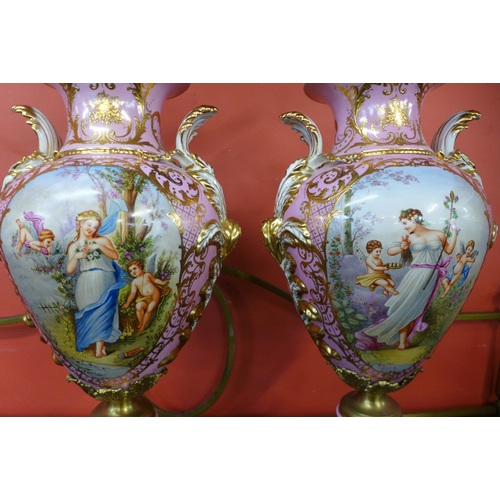 97 - A pair of large French style pink porcelain and gilt metal mounted vases and covers, with gilded dec... 