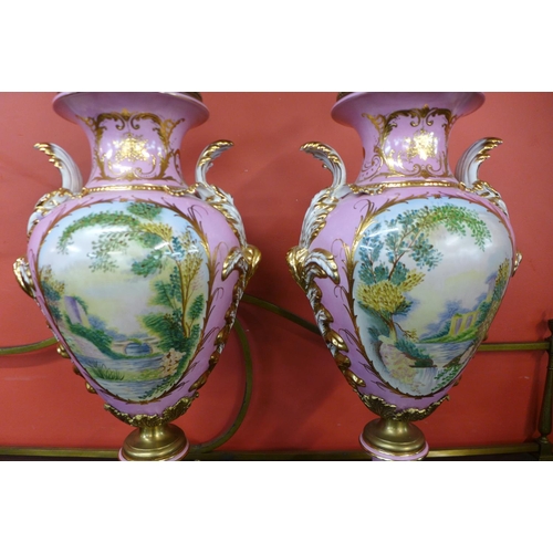 97 - A pair of large French style pink porcelain and gilt metal mounted vases and covers, with gilded dec... 