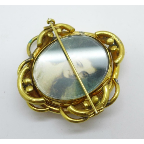 1008 - A Victorian gold plated swivel brooch, (with early photograph of a gentleman and a later image of a ... 