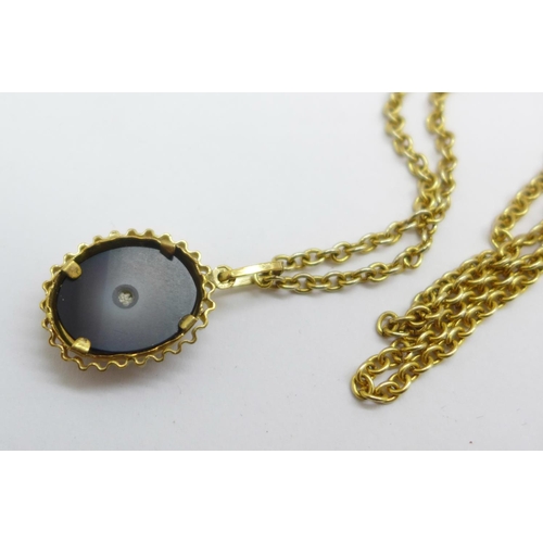 1048 - A 9ct gold bullseye agate pendant on a plated chain, pendant 2.4g