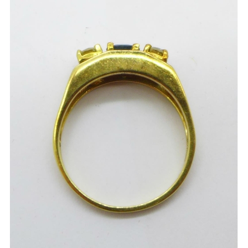 1052 - An 18ct gold, sapphire and diamond three stone ring, 4g, O, the diamonds approximately 0.25ct each