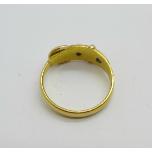 1071 - A yellow metal buckle ring set with a diamond and a sapphire, 4.7g, N