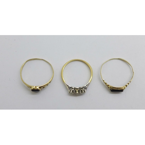 1073 - An 18ct gold, three stone diamond ring, 1.6g, N, and two 9ct gold rings, 1.7g, both Q/R