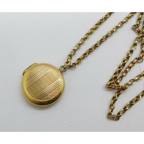 1077 - A 9ct gold back and front locket on a 9ct gold chain, chain 2.6g