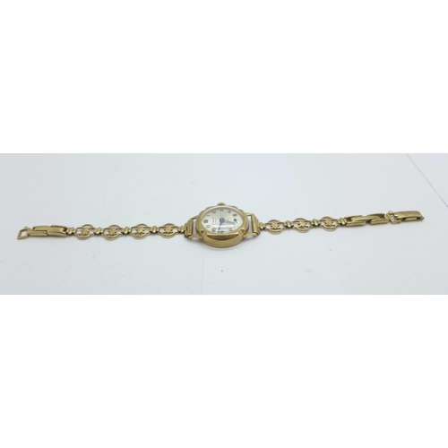 1109 - A lady's 9ct gold cased wristwatch on a 9ct gold bracelet strap, total weight with movement 14.5g