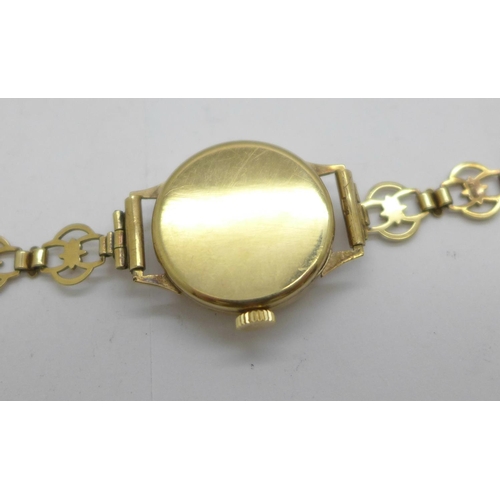 1109 - A lady's 9ct gold cased wristwatch on a 9ct gold bracelet strap, total weight with movement 14.5g