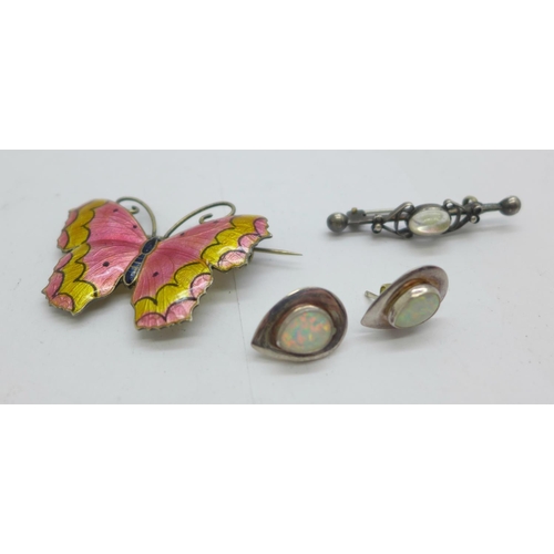 1115 - An enamelled silver butterfly brooch, a pair of silver and synthetic opal earrings and a silver broo... 