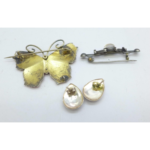 1115 - An enamelled silver butterfly brooch, a pair of silver and synthetic opal earrings and a silver broo... 