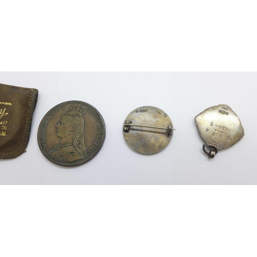 1128 - A Victorian silver crown, 1889, a silver football fob medal and a silver badge