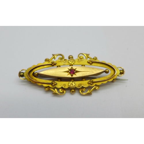 1137 - A 9ct gold and ruby brooch, 2.9g