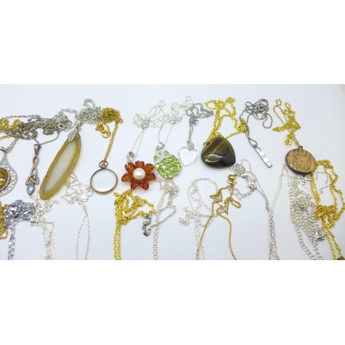 1157 - Thirty-one pendants with chains including silver, amber and hardstone