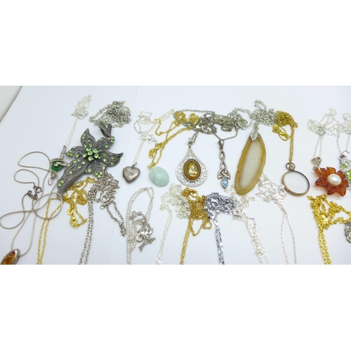 1157 - Thirty-one pendants with chains including silver, amber and hardstone