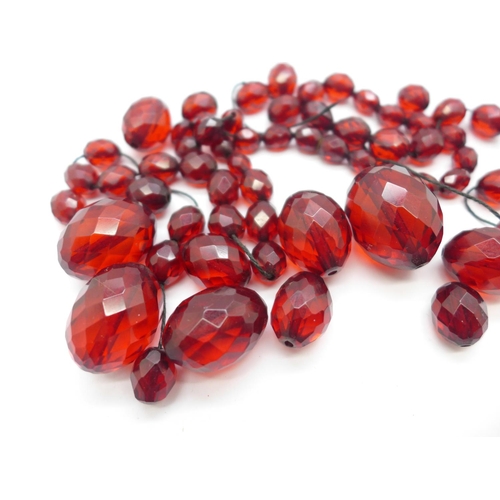 1161 - A sherry amber coloured faceted bead necklace, requires re-stringing